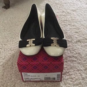 Tory Burch White Patent Leather with black bow.